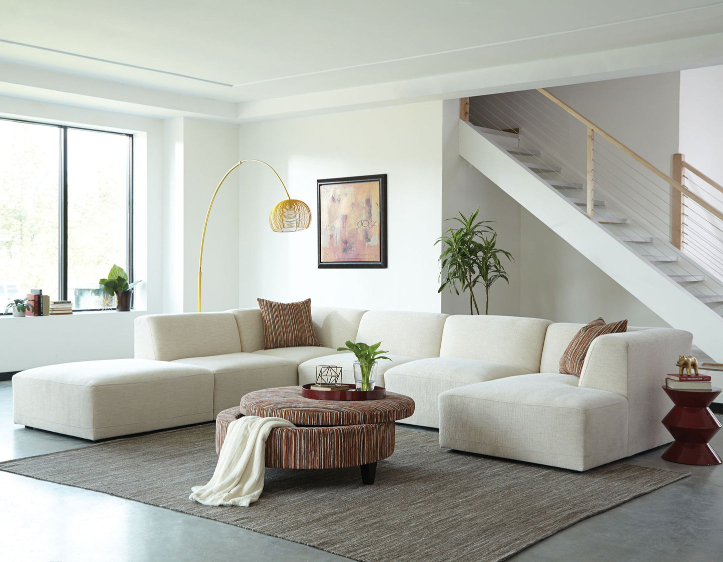 FINSBURY sectional in a modern living room with a staircase